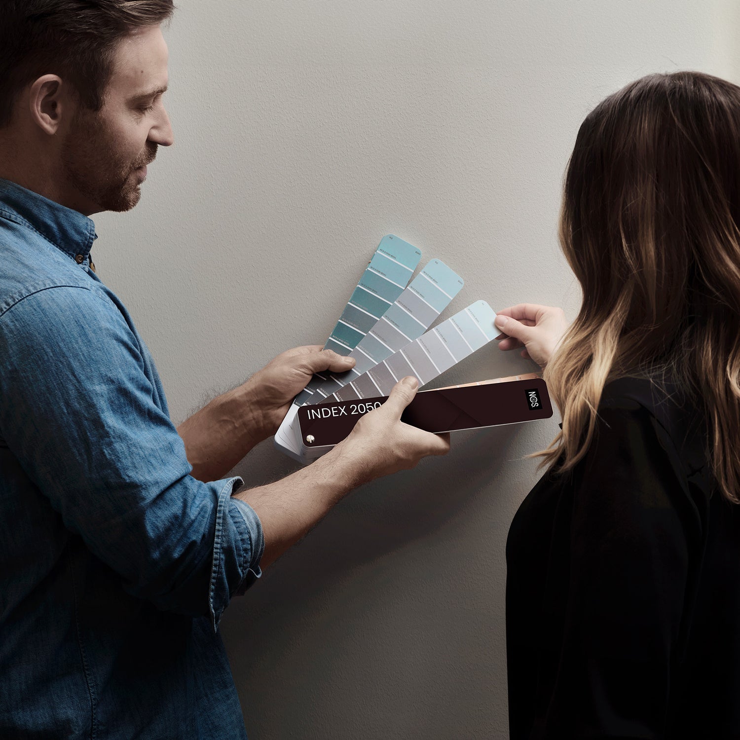 Two people holding the NCS Index 2050
