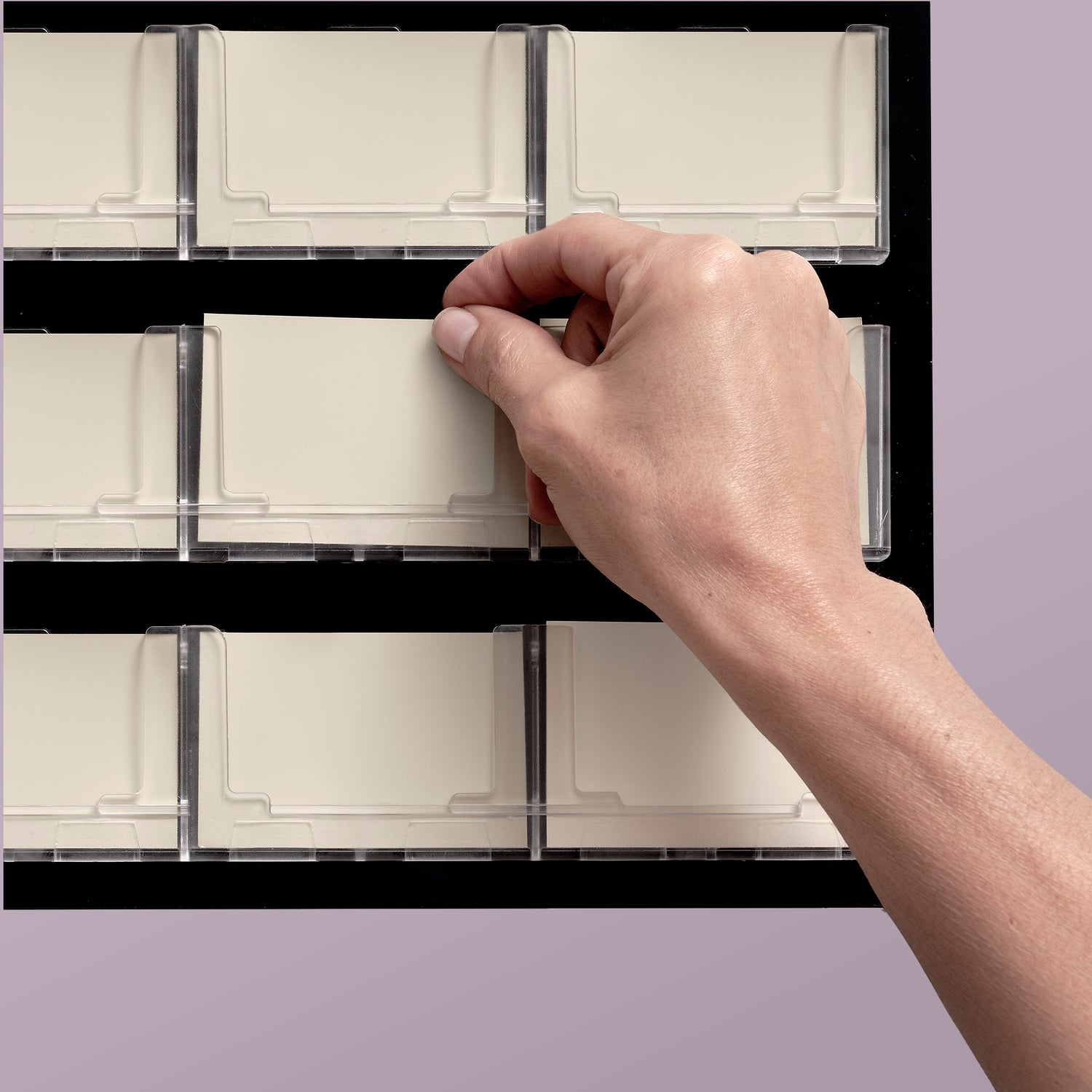 Hand selects a beige display sample