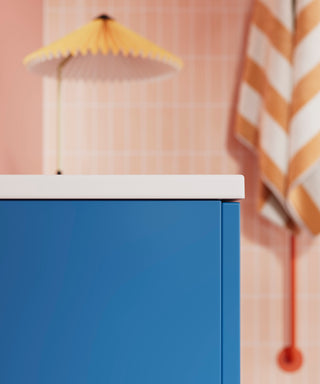 INR blue bathroom counter. yellow lamp and pink background